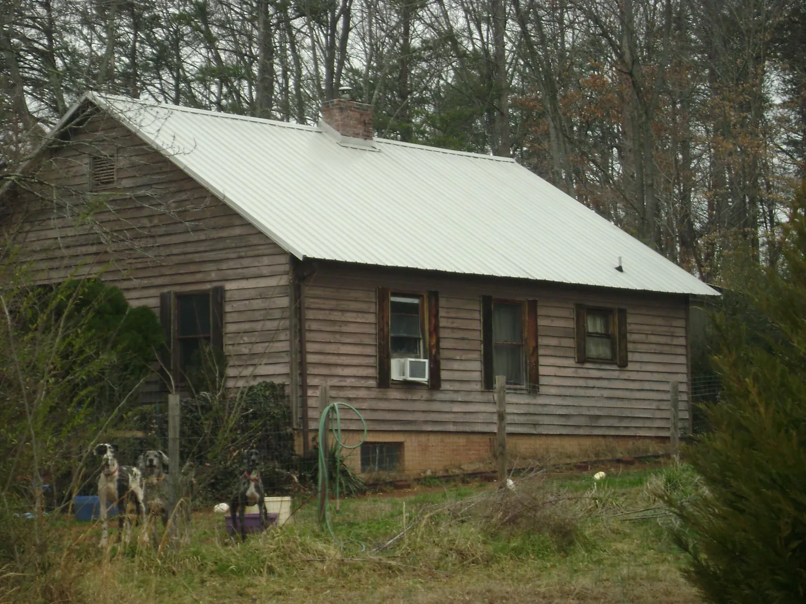 White metal roof on an old wood sided farmhouse, from a Metal Roof Installation job in Cohocton